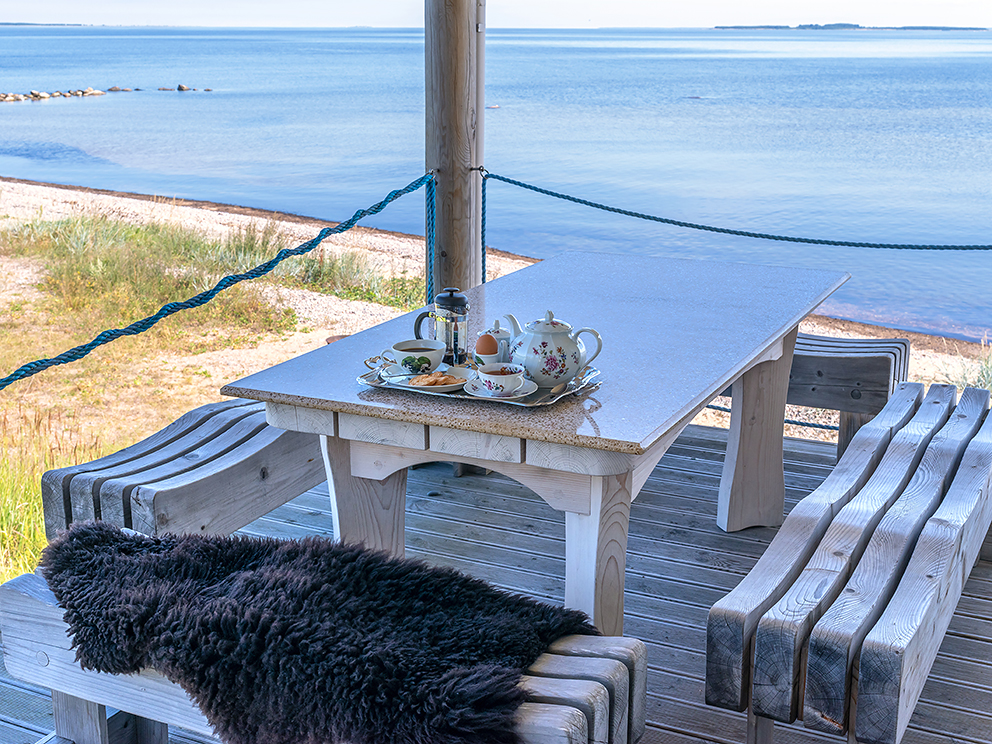 Rituel du matin : plateau du petit déjeuner transporté et dégusté sur la terrasse en bord de mer